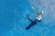 © David Zarzosa - Overhead view of a tennis player serving on a blue court.