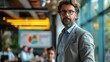© AIsofeel - A businessman in a suit and glasses looks thoughtfully towards the camera in a modern office setting.