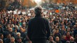 © MaxStock - Man Speaking to Large Crowd at Outdoor Event