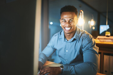 Poster - Night, desk and portrait of black man at computer with smile, happy and overtime at tech startup. Research, planning and businessman with confidence, networking and dark office at digital agency.