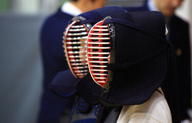 Seoul, South Korea - October 14, 2023: Interior and side view of two boy Kendo player in protecting gear standing for game in a gym
