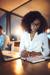 Canvas Print - Laptop, notebook and business woman at night in office with research for wealth management report with deadline. Computer, writing and African female actuary working overtime on financial investment.