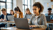 © NewFresh  - Young african american female student using laptop at desk in classroom