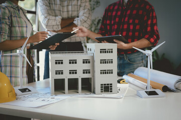 Wall Mural - team of architects is having a meeting in the office, working together on a new project for a sustai