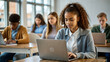 © NewFresh  - Portrait of female student using laptop in classroom with classmates in background