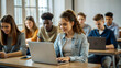 © NewFresh  - education, high school, technology and people concept - group of smiling students with laptop computers in lecture hall