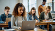 © NewFresh  - Group of young multiethnic students sitting in classroom and using laptop