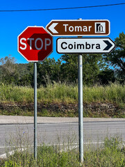 stop sign and 2 more signs with directions related to camino de santiago in portugal, the portuguese way, pilgrimage, St. James way