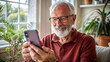 © NewFresh  - Senior man using a mobile phone at home in the living room.