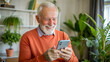 © NewFresh  - Portrait of a senior man using mobile phone while sitting at home