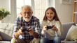 © NewFresh  - Grandfather and granddaughter playing video games. Grandfather and grandchild playing video games together.