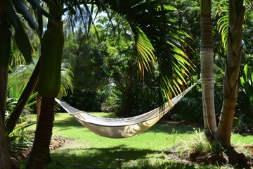 a hammock hanging between two palm trees