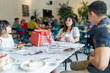 © Masakazu Tokashiki - A family of five, consisting of Chinese and Indian Malaysian adults, children, and a baby, enjoying a gathering at a stylish cafe in Selangor, Malaysia, on an early summer afternoon.