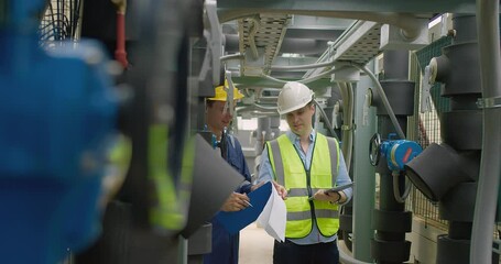 Poster - Civil engineer manager and foreman worker checking industry cooling air conditioner water cooling tower air chiller of large industrial building to control air system at construction site