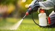 © sorin - Worker applying pest control spray on lush green lawn for effective pest management