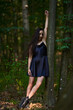 © Xalanx - Young woman in mini black dress in the forest