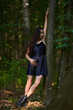 © Xalanx - Young woman in mini black dress in the forest