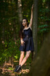 © Xalanx - Young woman in mini black dress in the forest
