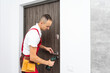 © Angelov - Portrait Young Male Carpenter Repairing Door Lock