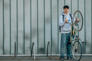 Poster - urban scene of young man with vintage bicycle