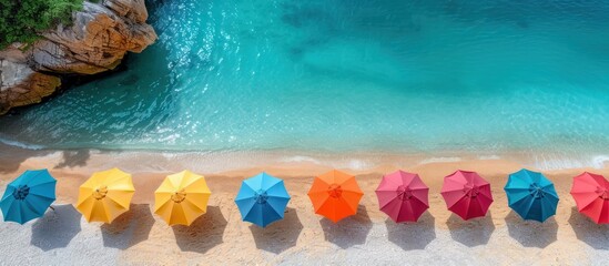 Wall Mural - Aerial View of Colorful Beach Umbrellas on Sandy Shore