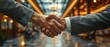 © Naret - Photography of a businessman shaking hands, medium shot with blurred modern office background. Space for text.
