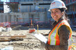 © Faisal - A woman in her 30s with dark hair pulled back, wearing a hard hat, high-vis vest