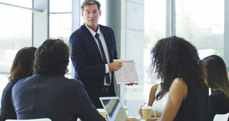 Wall Mural - Coaching, presentation and tablet with business people in boardroom of office together for feedback. Information, training and technology with man employee talking to investors in workplace for intro