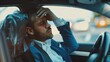 © chutikan - Upset businessman sitting in front seat inside car and touching his head