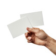 © malai - Two white cards are being held in a hand