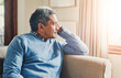 © TamJam/peopleimages.com - Thinking, depression and senior man in home to remember past memory, mistake or reflection of decision. Alzheimer, retirement and sad person on sofa with dementia, nostalgia or lonely in living room