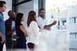 © ThurstanBuyout/peopleimages.com - Business, people and communication with glass in office for campaign management, collaboration and work. Sales directors, conversation and graphs for revenue, development and income growth or review.