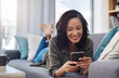 © ReeseArcurs/peopleimages.com - Woman, relax and cellphone on couch for blog, social media and reading or streaming in home. Sofa, smile and female person in living room or lounge for connection, scroll or mobile app for networking