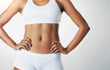 © peopleimages.com - Fitness, underwear and stomach of woman in studio for weight loss, wellness and exercise on white background. Skincare, health and isolated abdomen of person for workout, diet and slim figure