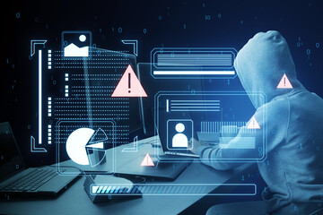 Wall Mural - A hooded figure using a laptop with cyber security graphics overlay, symbolizing a cyber attack on a dark blue background