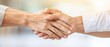 © Pual GotoMars - Close-up of two people shaking hands, showcasing trust and partnership in a professional setting with a soft background.