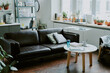 © AnnaStills - Medium close up of black leather sofa in center of recreation area in on call room