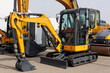 © Studio Peace - New mini excavators in the same row in the agricultural machinery store.