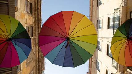 Colorful rainbow umbrellas on Pink Street in Lisbon, Portugal