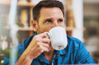 © SunriseDon/peopleimages.com - Man, drinking coffee and home for break, relax and comfort with thinking, planning and ideas for travel. Male person, hot beverage and reflection with memory, nostalgia and contemplating for vacation