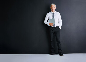 Poster - Business man, laptop and happy in studio by space, portrait and mock up by black background. Mature person, executive or actuary with computer for risk assessment at insurance agency in Australia