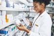 © JorSons/peopleimages.com - Black woman, tablet and pharmacist check medicine for stock, inventory or reading label on box at shelf. Tech, smile and medical worker with drugs for online prescription, information or telehealth