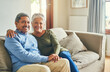© peopleimages.com - Smile, portrait or senior couple on couch for hug, wellness or proud for financial stability. Senior woman, happy man and love in living room for commitment, comfort and milestone in marriage at home