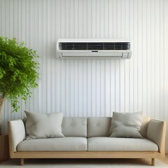 A modern, minimalist living room features a light grey sofa positioned against a white wall, beneath a mounted air conditioner.