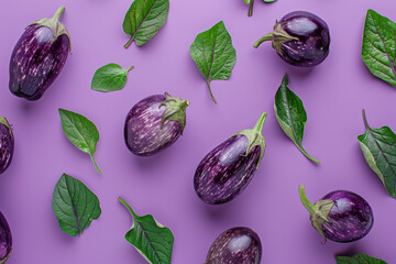 Wall Mural - Fresh Eggplants with Green Leaves Spread on Vibrant Purple Background for Creative Food