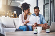 © peopleimages.com - Finance, laptop and couple with documents on sofa for bills, life insurance or mortgage. Lens flare, paperwork and black man with woman on computer for planning budget, payment or investment in home