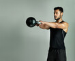 © ThurstanBuyout/peopleimages.com - Studio, athlete or Indian man with kettlebell or muscle for health, wellness or gym on grey background. Strong bodybuilder, swing or male person with weight for fitness training, workout or power