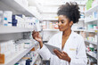 © JorSons/peopleimages.com - Black woman, tablet and pharmacist check inventory for medicine, stock or reading product label. Tech, pharmacy and medical worker with drugs for online prescription order, information or healthcare