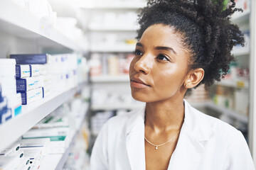 Canvas Print - Black woman, thinking and pharmacist with shelf in clinic of medicine stock, check and information for prescription. Healthcare, female person and pills choice, medical inventory and pharmacy advice