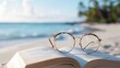 © TENTIP - A pair of eyeglasses resting on an open book on a sandy beach with a calm ocean and palm trees in the background.